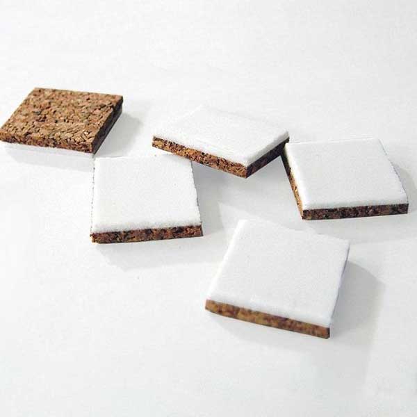 How do cork pads with adhesive foam protect laminate flooring from moisture damage